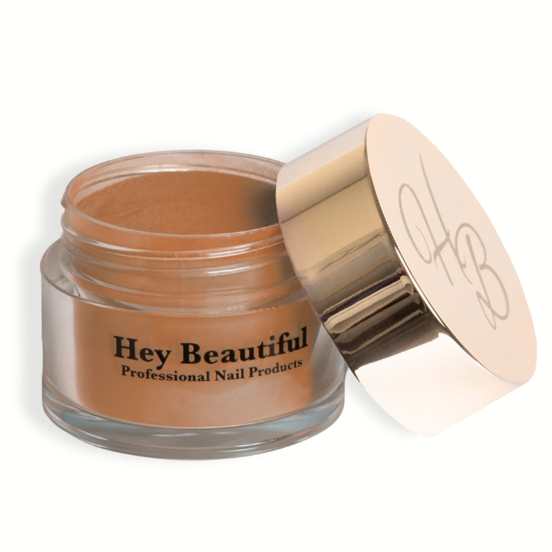 Jar of Heavy Pumpkin Acrylic Powder featuring Hey Beautiful’s iconic champagne-colored logo on the cap, highlighting its elegant packaging.