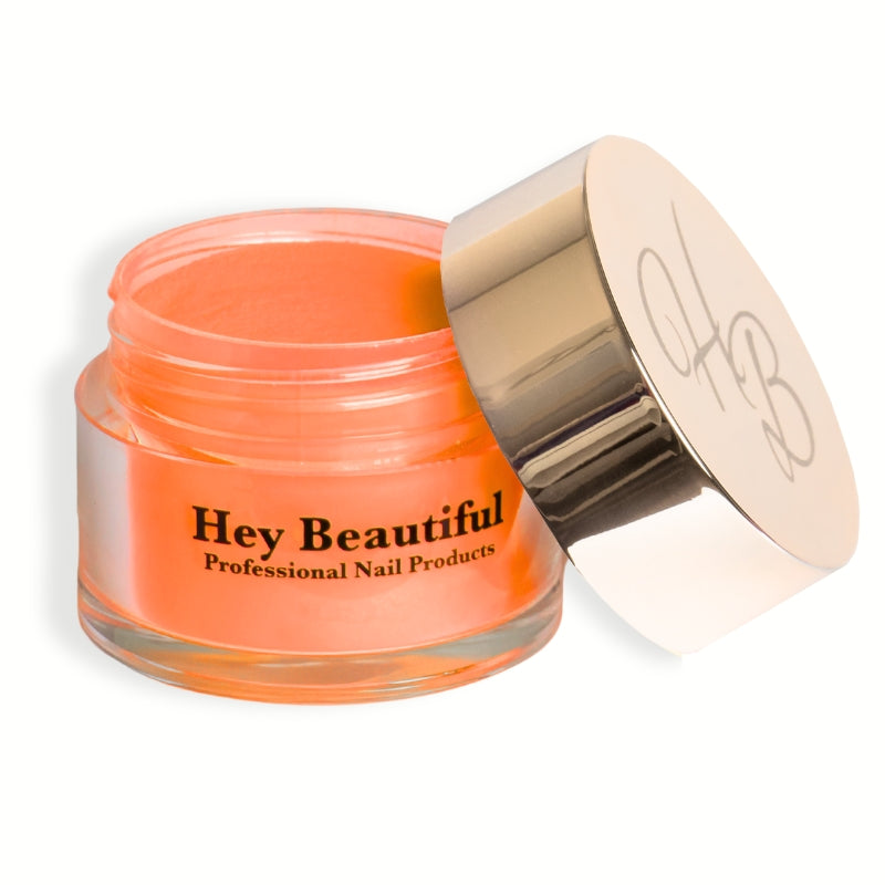 Jar of Neon Orange Acrylic Powder with Hey Beautiful’s iconic champagne-colored logo on the cap, highlighting its bold, vibrant packaging.