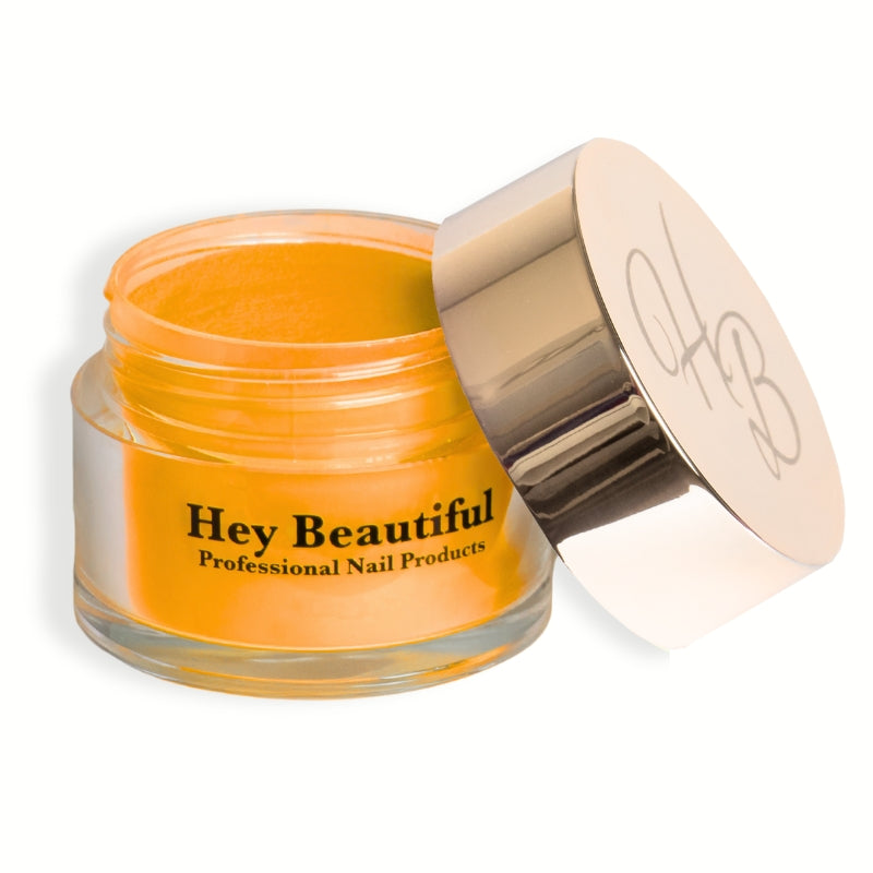 Jar of Pure Yellow Acrylic Powder with Hey Beautiful’s champagne-colored logo on the cap, highlighting its rich, burnt yellow tone and premium packaging.